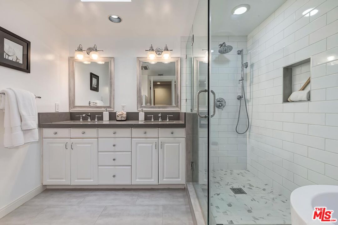 751 Teakwood Road Los Angeles, CA 90049 - Photo 27 of 46 a bathroom with a double vanity sink mirror and shower
