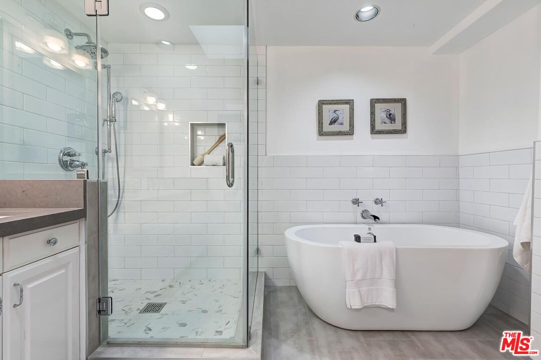 751 Teakwood Road Los Angeles, CA 90049 - Photo 28 of 46 a white bath tub sitting in a bathroom