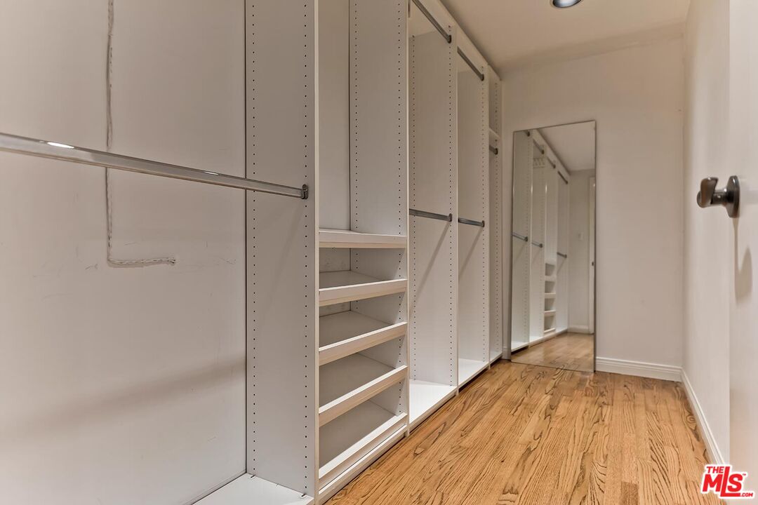 751 Teakwood Road Los Angeles, CA 90049 - Photo 29 of 46 a view of walk in closet with empty racks