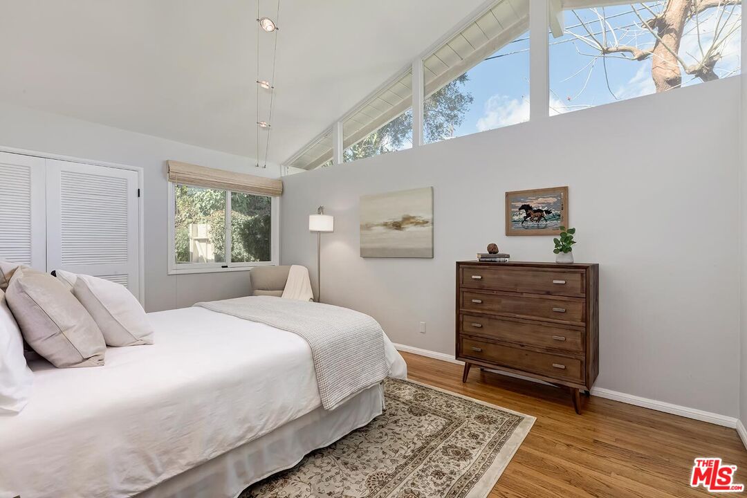 751 Teakwood Road Los Angeles, CA 90049 - Photo 30 of 46 a bedroom with a bed and a window