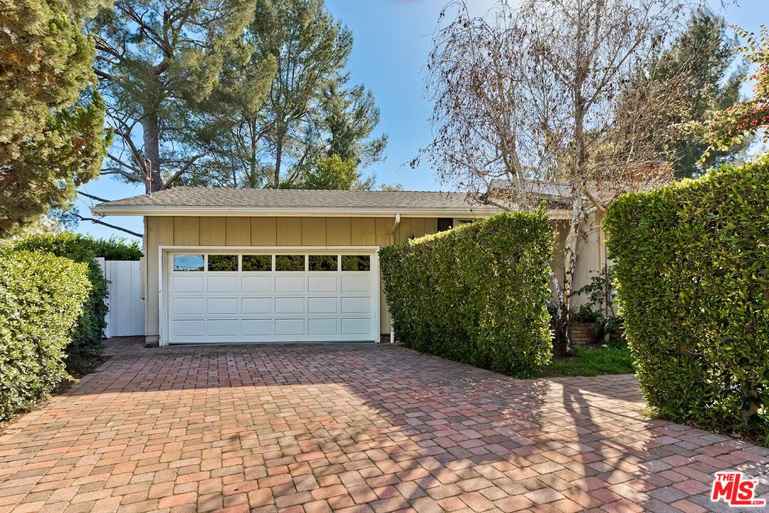 751 Teakwood Road Los Angeles, CA 90049 - Photo 3 of 46 a view of a house with a yard
