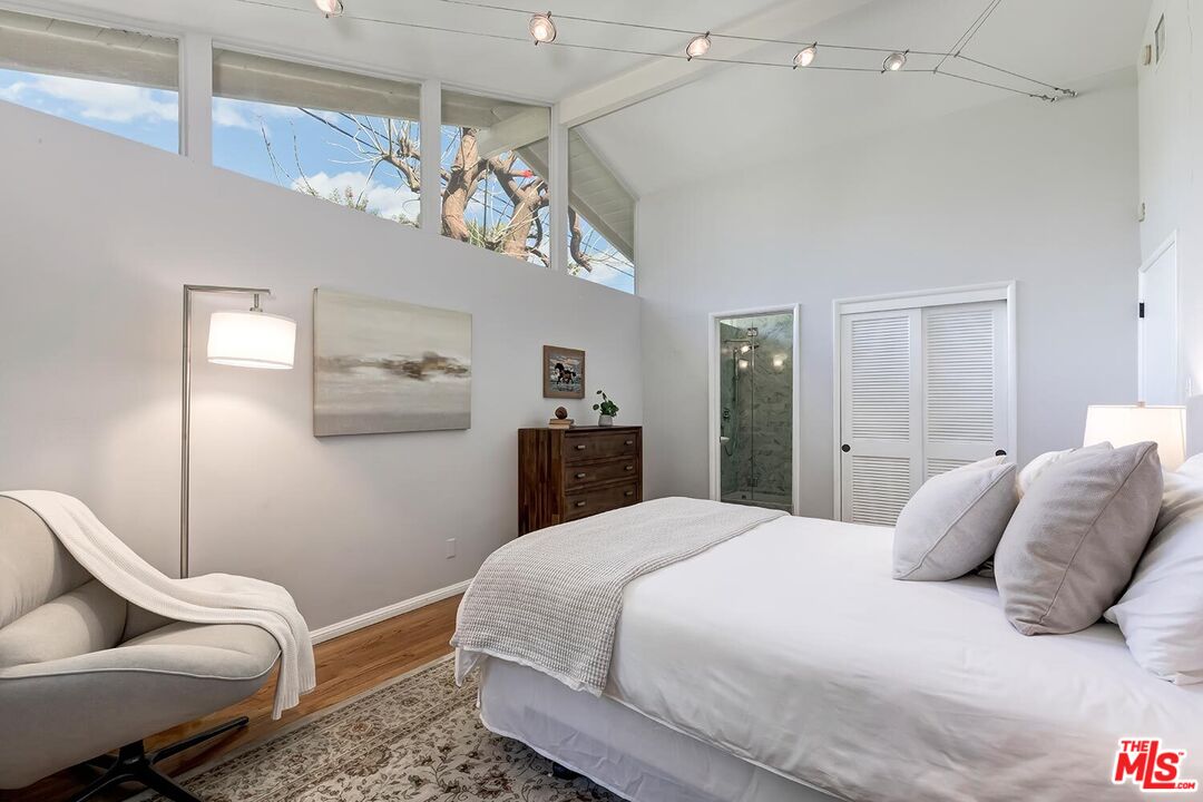 751 Teakwood Road Los Angeles, CA 90049 - Photo 31 of 46 a bedroom with a bed and ceiling fan
