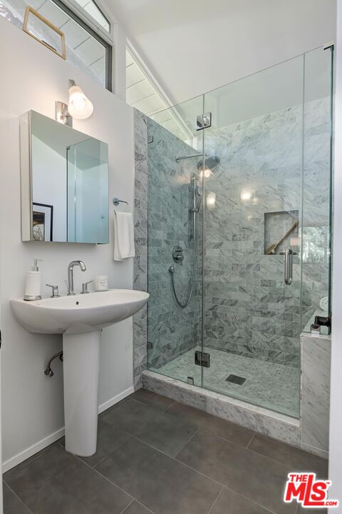 751 Teakwood Road Los Angeles, CA 90049 - Photo 32 of 46 a bathroom with a sink a shower and mirror
