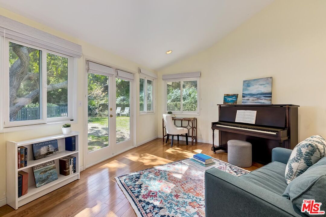 751 Teakwood Road Los Angeles, CA 90049 - Photo 37 of 46 a living room with furniture and a fireplace