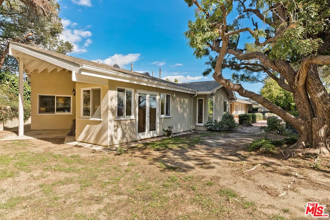 751 Teakwood Road Los Angeles, CA 90049 - Photo 38 of 46 a view of a white house with a yard