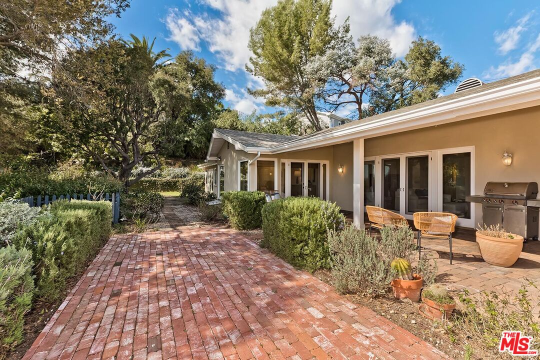 751 Teakwood Road Los Angeles, CA 90049 - Photo 43 of 46 a view of a house with backyard sitting area and garden