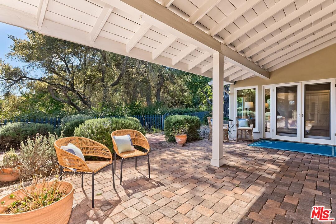 751 Teakwood Road Los Angeles, CA 90049 - Photo 46 of 46 a view of a chairs and table in backyard