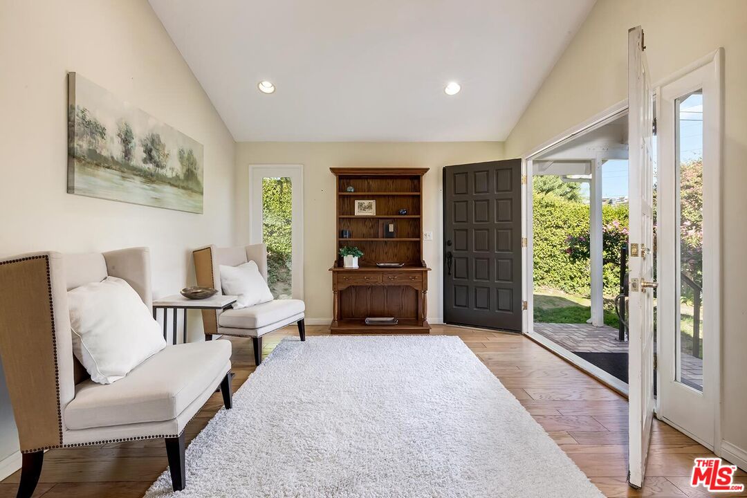 751 Teakwood Road Los Angeles, CA 90049 - Photo 6 of 46 a living room with furniture and a flat screen tv