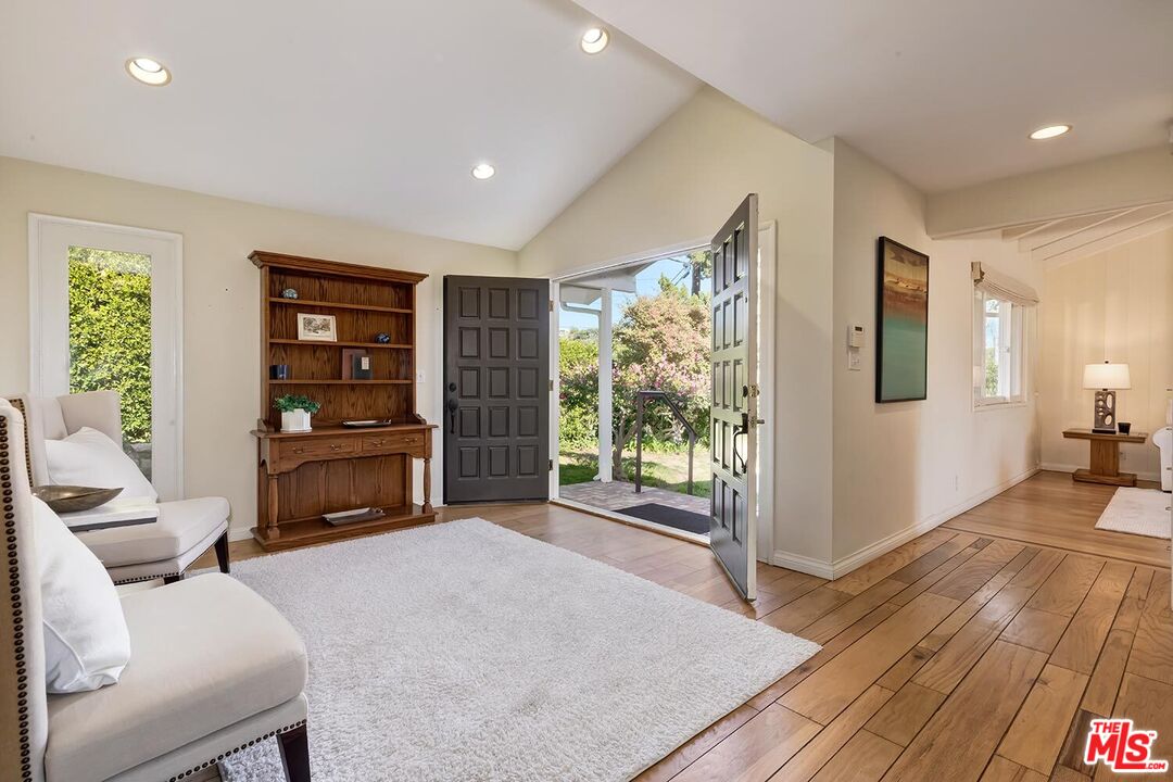 751 Teakwood Road Los Angeles, CA 90049 - Photo 7 of 46 a living room with furniture a large window with wooden floor