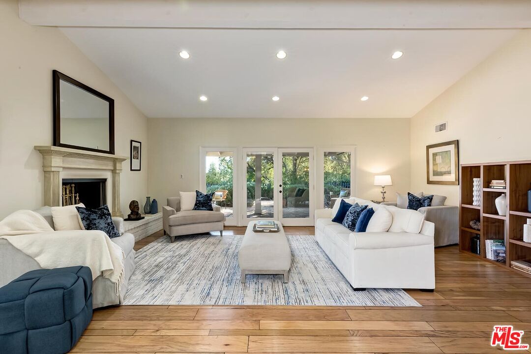 751 Teakwood Road Los Angeles, CA 90049 - Photo 8 of 46 a living room with furniture fireplace and flat screen tv