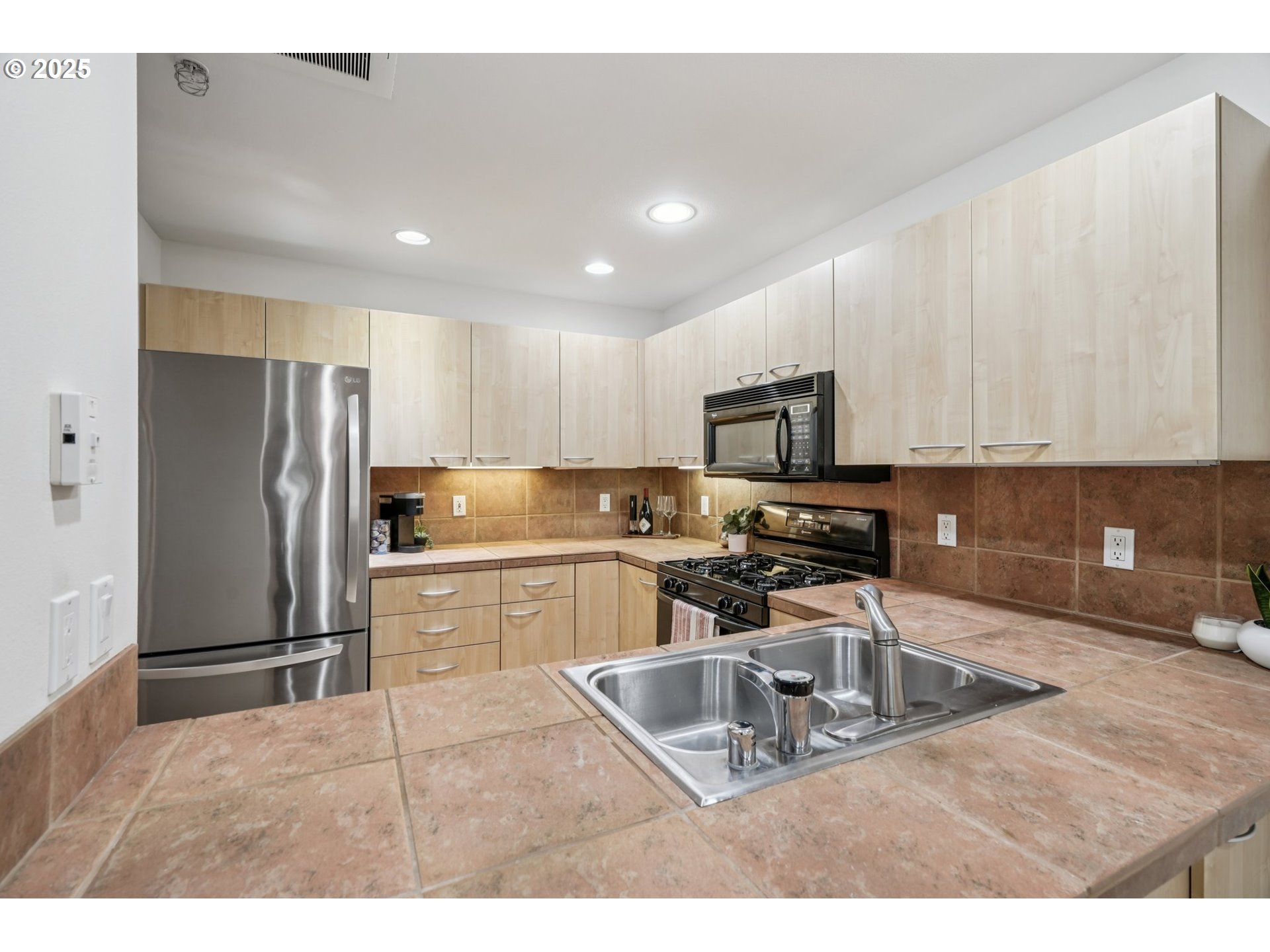 300 West 8th Street, Unit 206 Vancouver, WA 98660 - Photo 9 of 42 a kitchen with stainless steel appliances granite countertop a refrigerator sink and stove