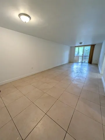 an empty room with a empty space and windows