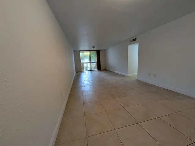 a view of an empty room and a window