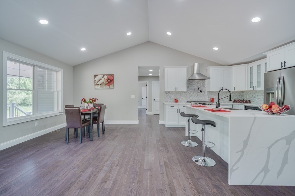 40 Mort Vining Road Southwick, MA 01077 - Photo 11 of 32 a kitchen with stainless steel appliances granite countertop a dining table chairs stove refrigerator and cabinets