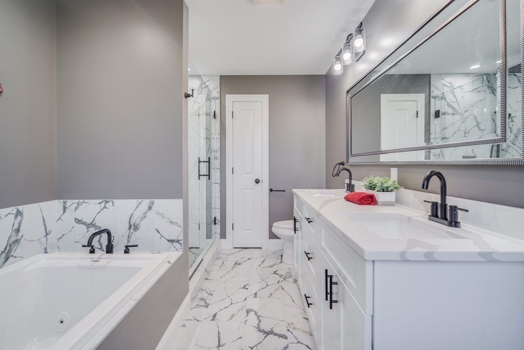 40 Mort Vining Road Southwick, MA 01077 - Photo 17 of 32 a bathroom with a tub sink and mirror