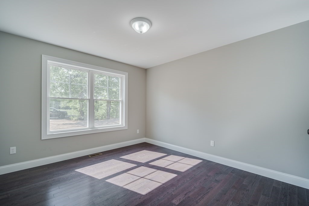 40 Mort Vining Road Southwick, MA 01077 - Photo 19 of 32 an empty room with wooden floor and windows