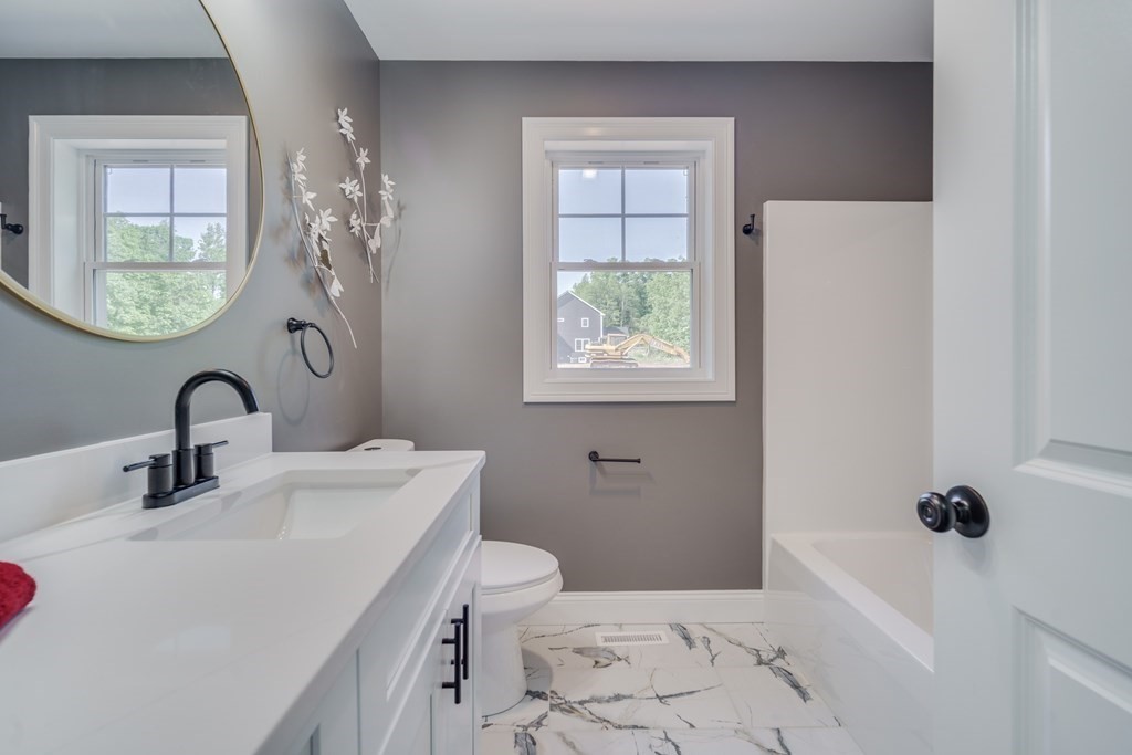 40 Mort Vining Road Southwick, MA 01077 - Photo 21 of 32 a bathroom with a sink a toilet and shower