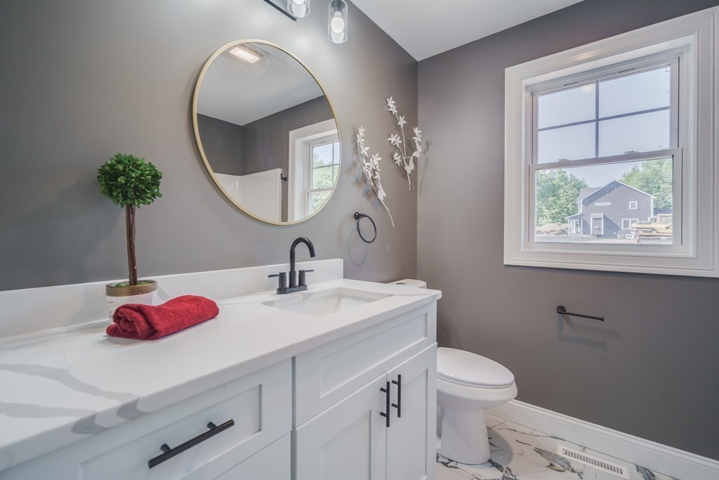 40 Mort Vining Road Southwick, MA 01077 - Photo 22 of 32 a bathroom with a toilet sink and mirror