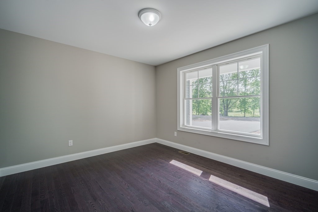 40 Mort Vining Road Southwick, MA 01077 - Photo 23 of 32 an empty room with wooden floor and windows