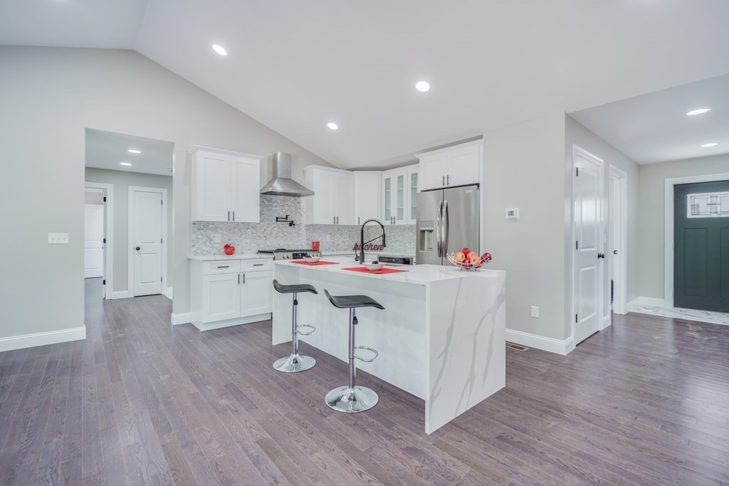 40 Mort Vining Road Southwick, MA 01077 - Photo 4 of 32 a kitchen with a sink a refrigerator and white cabinets