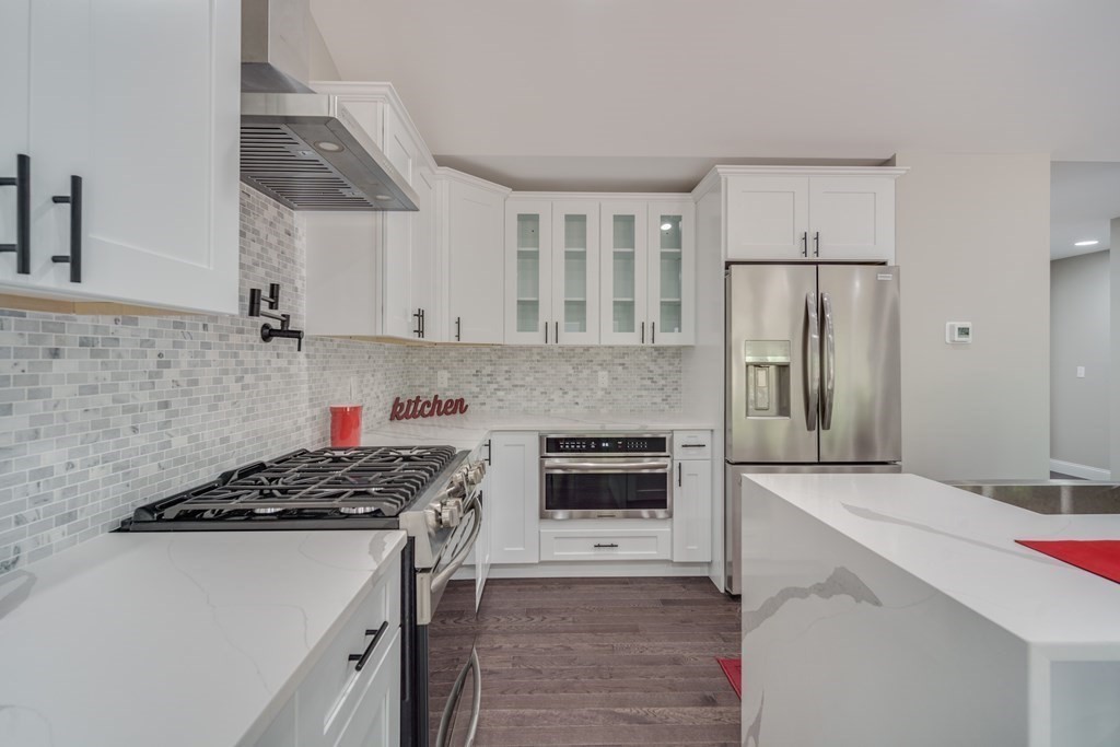 40 Mort Vining Road Southwick, MA 01077 - Photo 6 of 32 a kitchen with stainless steel appliances a stove a sink and a refrigerator