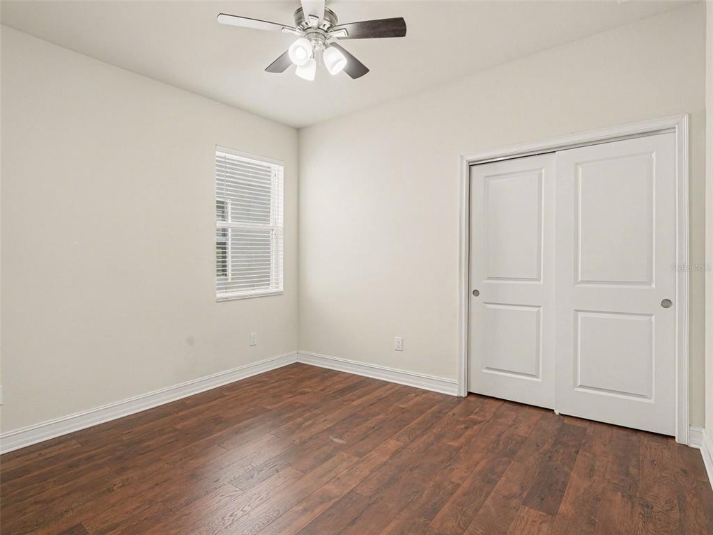 4429 Conchfish Lane Osprey, FL 34229 - Photo 14 of 20 a view of an empty room with wooden floor and a window