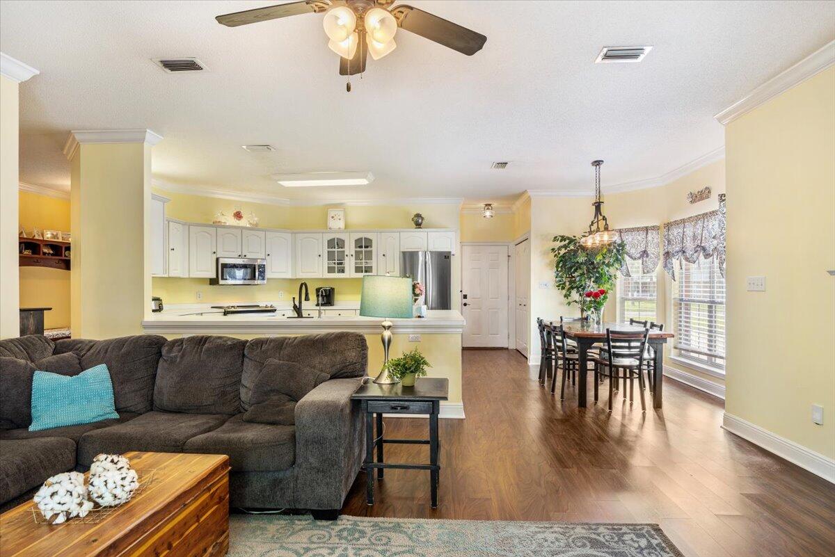 1830 Seahawk Lane Navarre, FL 32566 - Photo 13 of 53 a living room with furniture and wooden floor