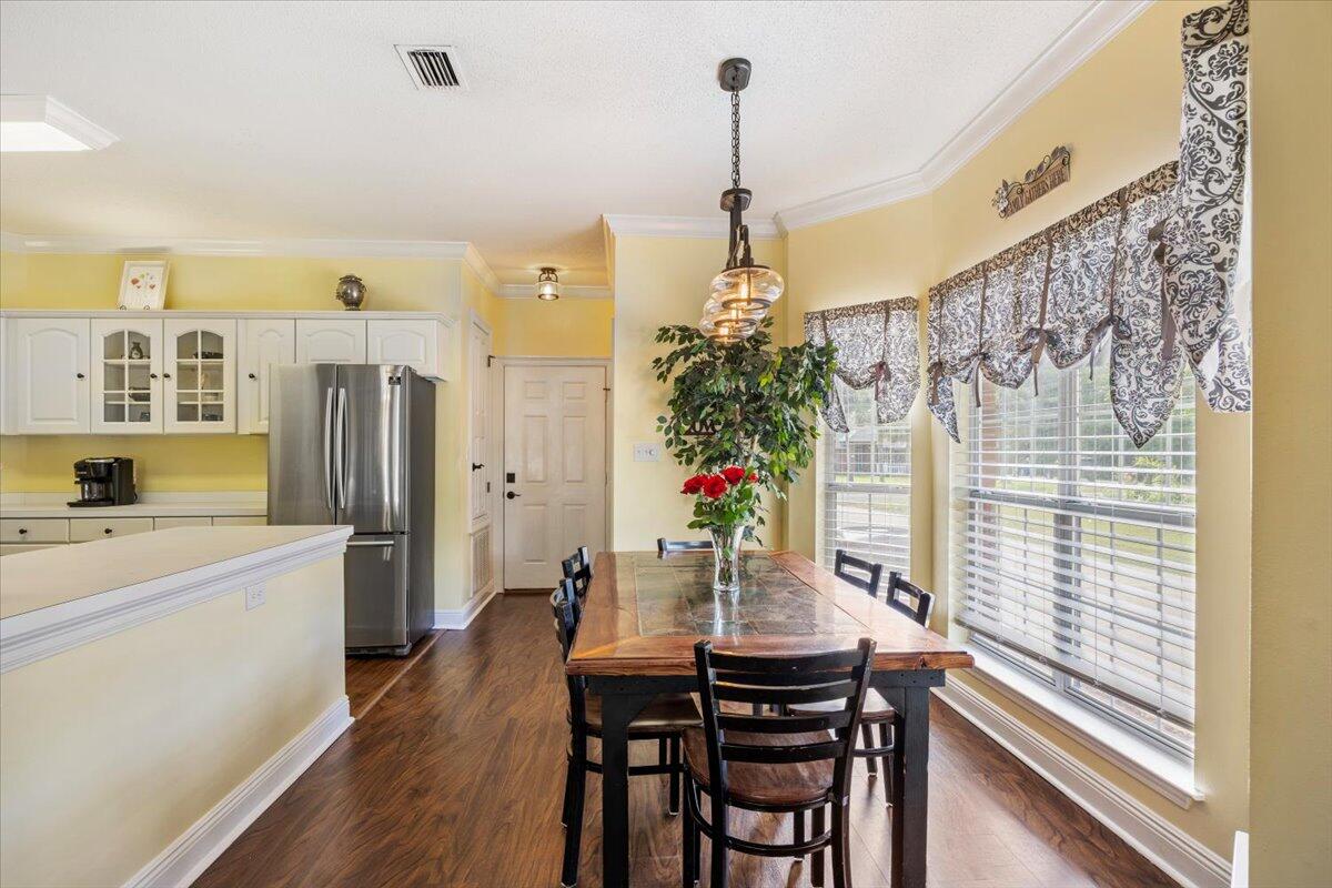 1830 Seahawk Lane Navarre, FL 32566 - Photo 16 of 53 a view of a kitchen with a table and chairs