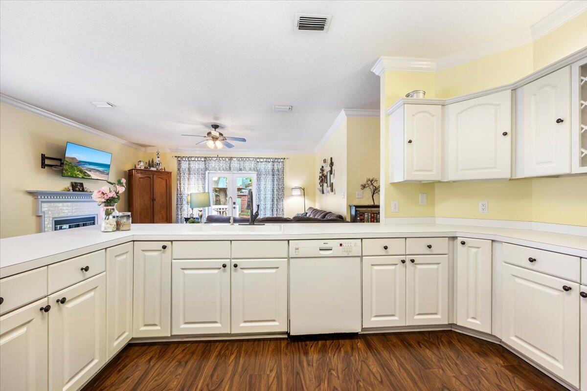 1830 Seahawk Lane Navarre, FL 32566 - Photo 21 of 53 a kitchen with white cabinets white appliances and sink