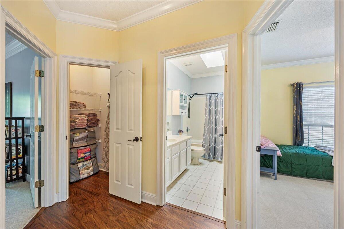 1830 Seahawk Lane Navarre, FL 32566 - Photo 23 of 53 wooden floor with closet and a livingroom view
