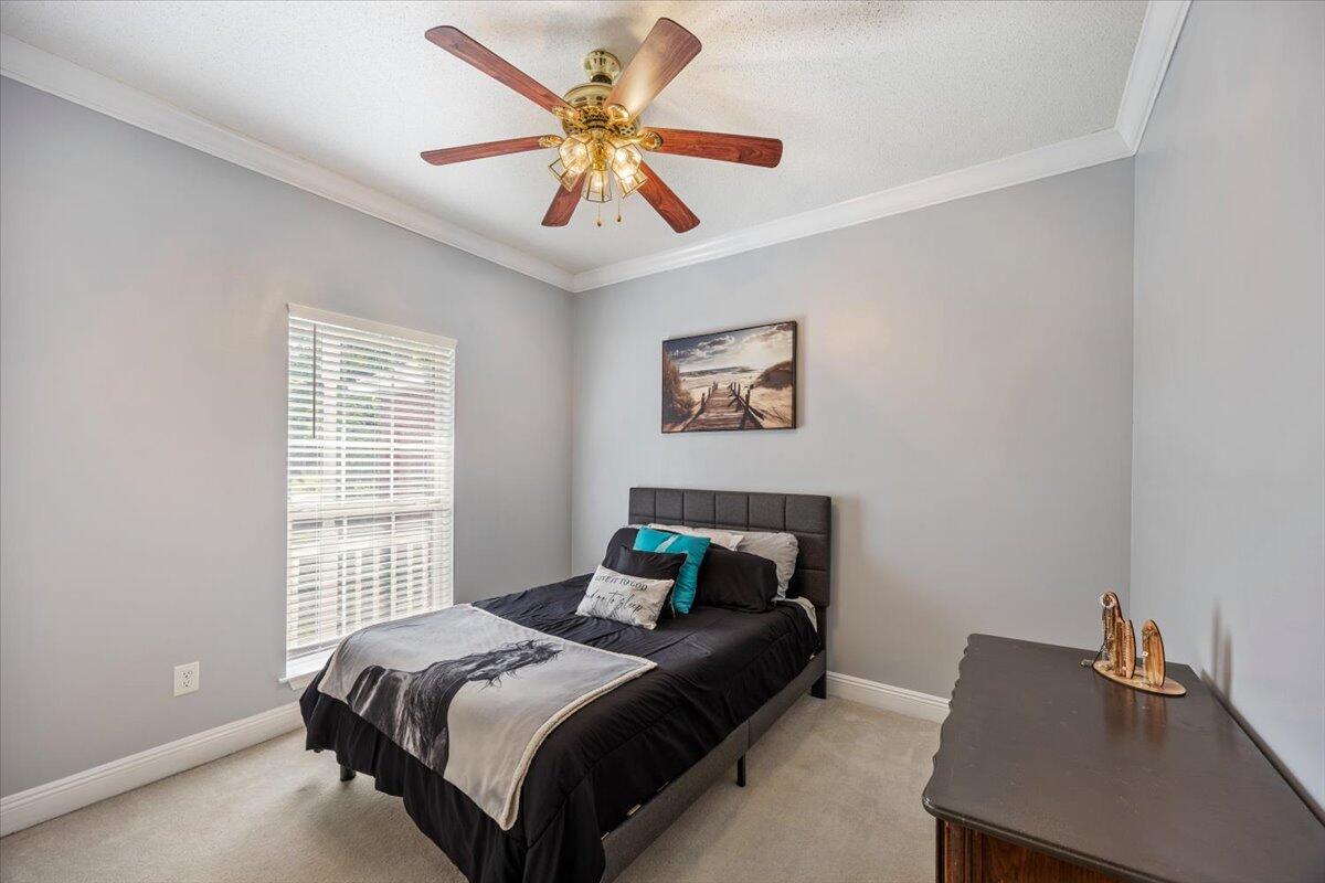 1830 Seahawk Lane Navarre, FL 32566 - Photo 27 of 53 a bedroom with a bed and a window