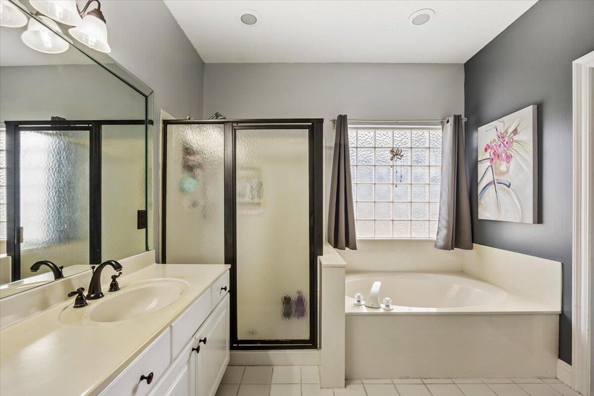 1830 Seahawk Lane Navarre, FL 32566 - Photo 31 of 53 a bathroom with a tub sink and mirror