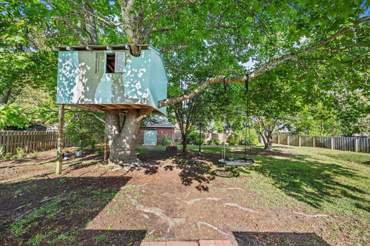 1830 Seahawk Lane Navarre, FL 32566 - Photo 44 of 53 a view of backyard with a table and chairs and wooden fence