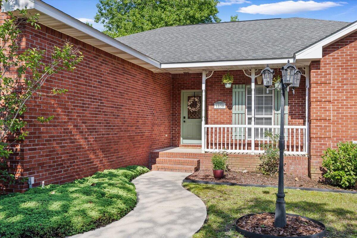 1830 Seahawk Lane Navarre, FL 32566 - Photo 5 of 53 a front view of a house with a garden