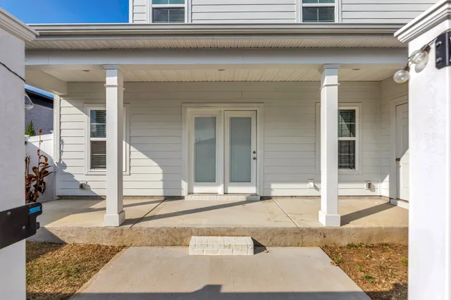 a view of house with wooden door and outdoor seating