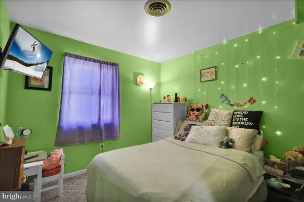 a bed room with a bed and a television