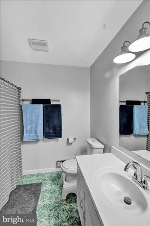 a bathroom with a sink toilet and mirror