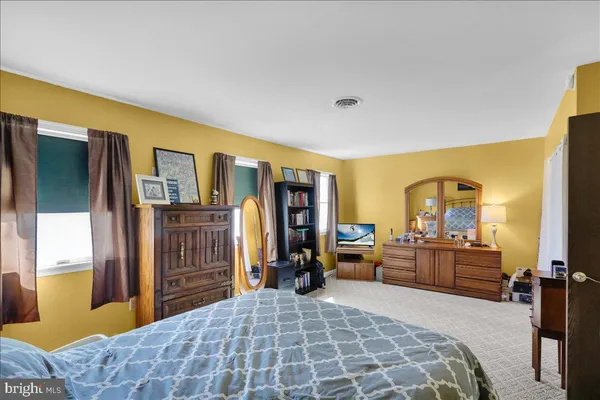 a bedroom with a bed closet and a large window