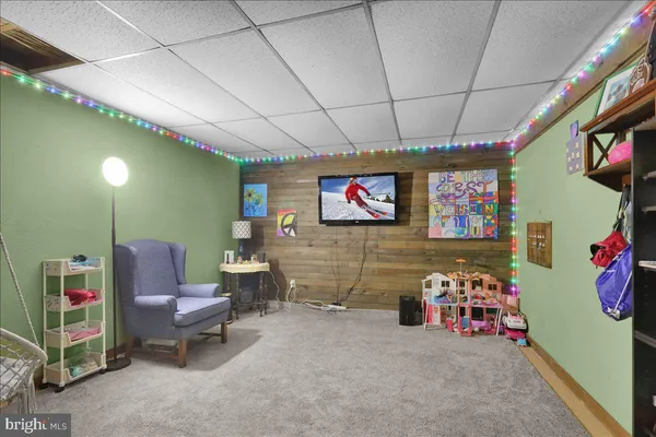 a room with furniture a flat screen tv and a couch