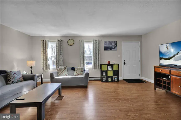 a living room with furniture and a flat screen tv