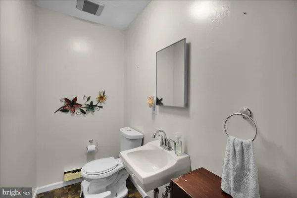 a bathroom with a sink toilet and a mirror