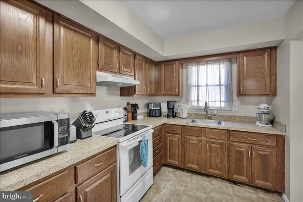 a kitchen with a sink stove and cabinets