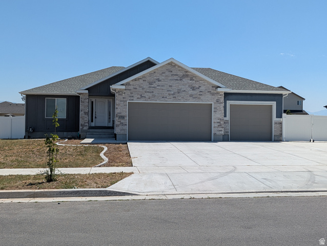 171 South Mustang Road East Grantsville, UT 84029 - Photo 34 of 41 Contemporary ranch-style residence featuring a combination of stone veneer and dark gray siding