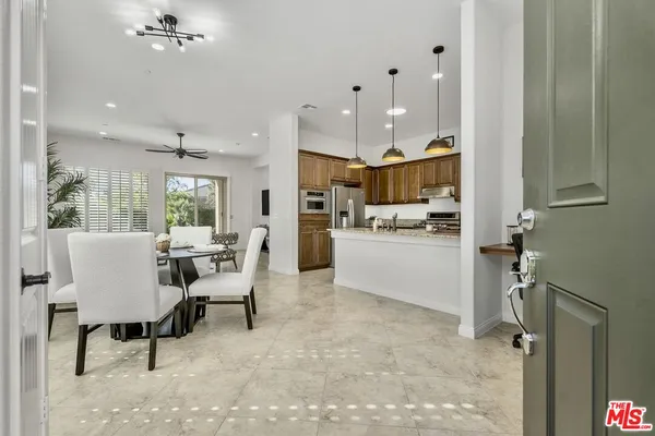 a view of a dining room with furniture and a kitchen