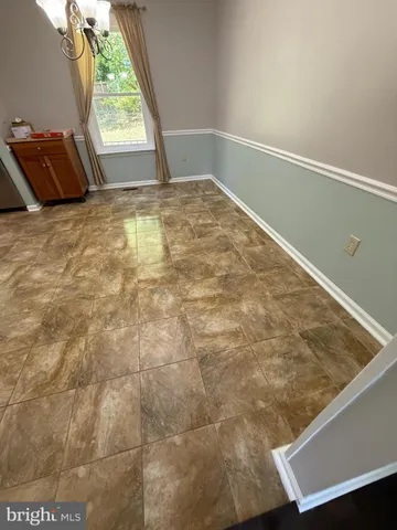 a view of an empty room and a window
