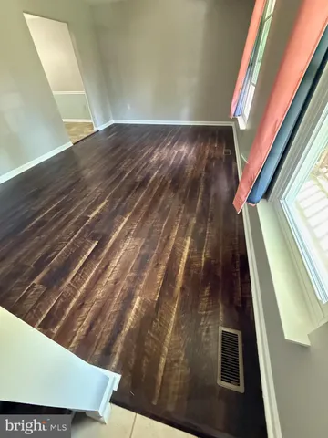 a large white kitchen with a large window