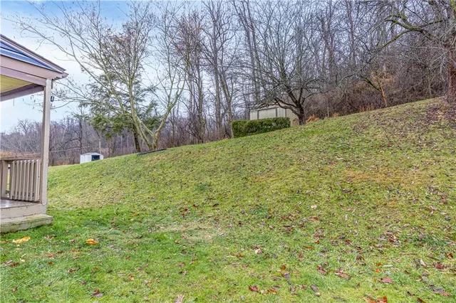 a view of a house with a yard balcony and sitting area