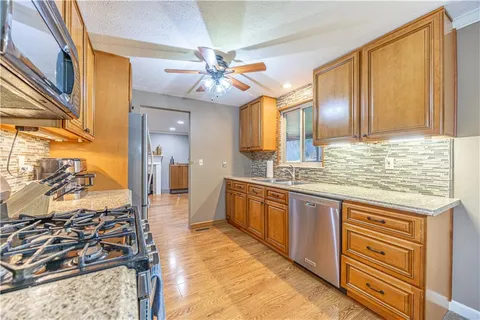 a spacious bathroom with a granite countertop sink and a mirror