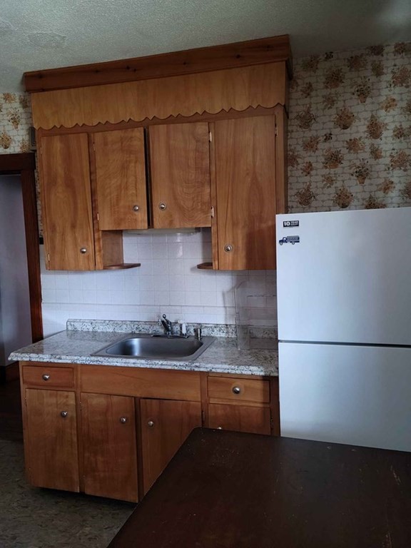 57 Austin Street, Unit 2 Boston, MA 02136 - Photo 14 of 17 a kitchen with a sink a stove and a refrigerator