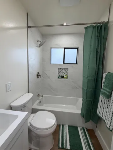 a bathroom with a toilet a sink and bathtub